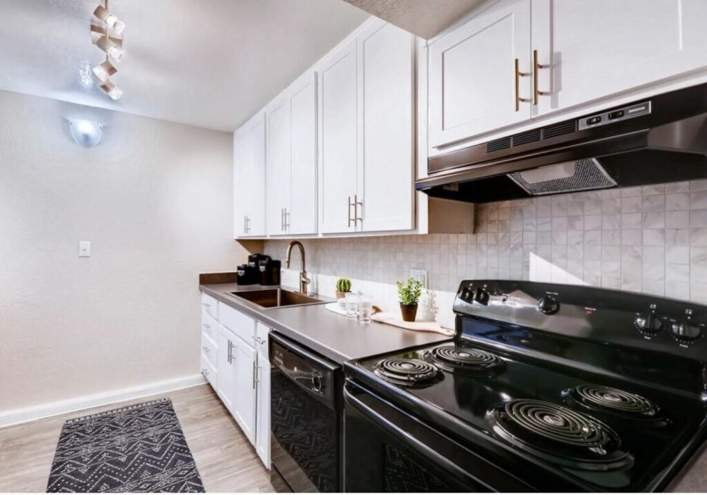 Apartment kitchen with cabinets and black appliances