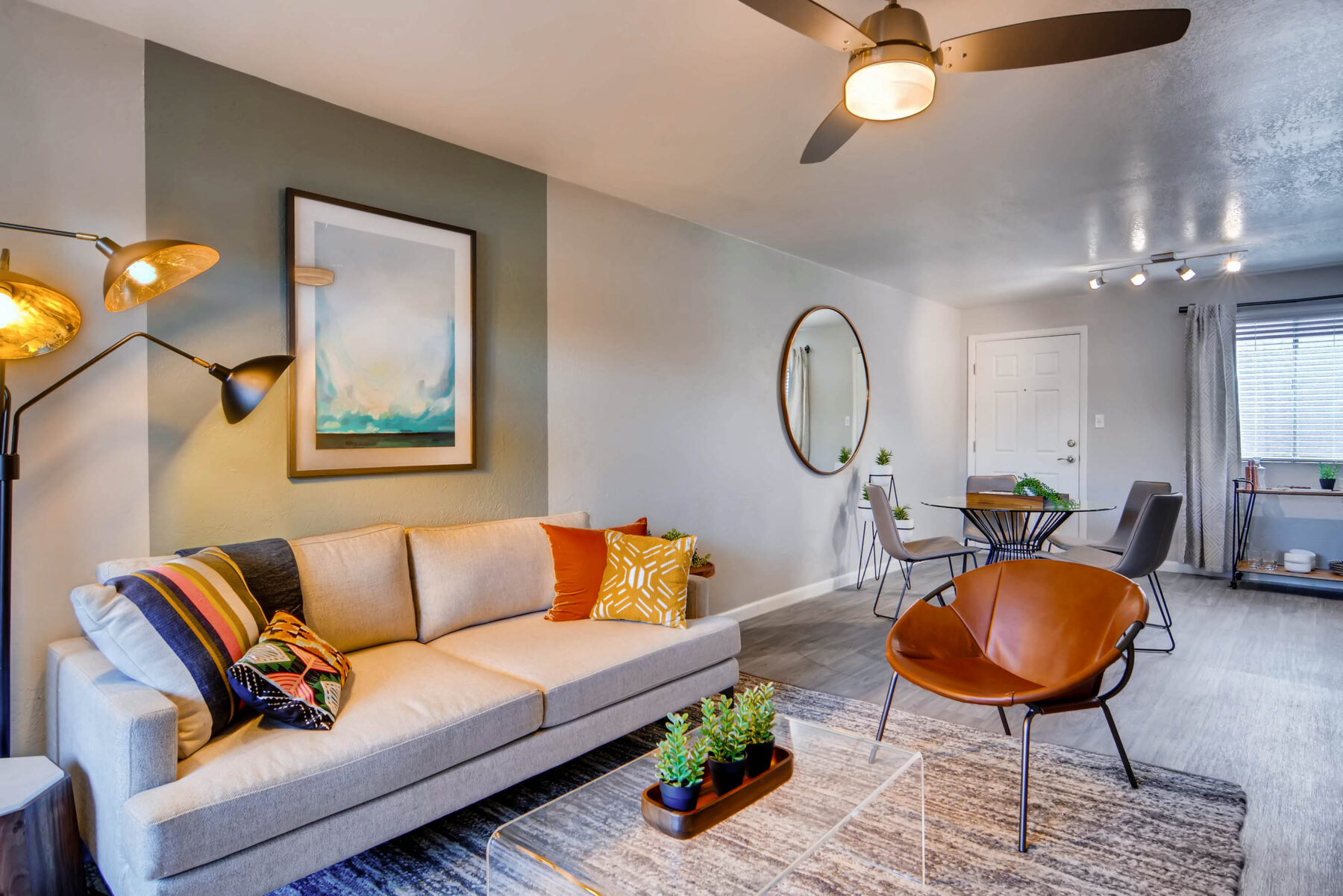 Living room near dining area with window and wood-style flooring