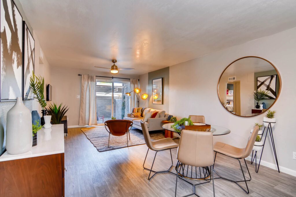 Dining area near kitchen and living room with window and wood-style flooring