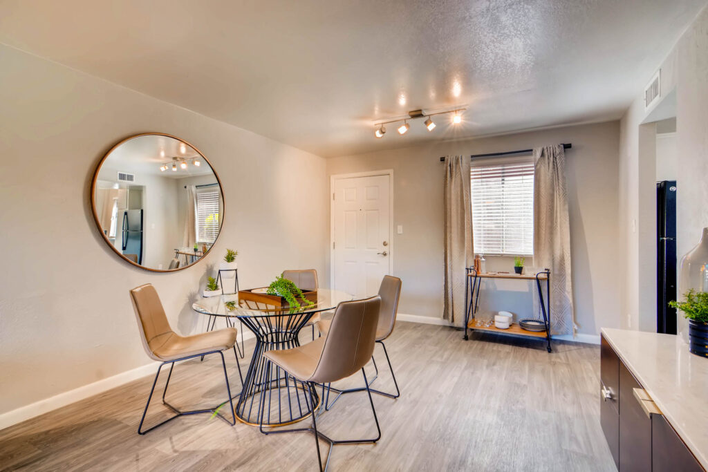 Dining area near kitchen with window and wood-style flooring