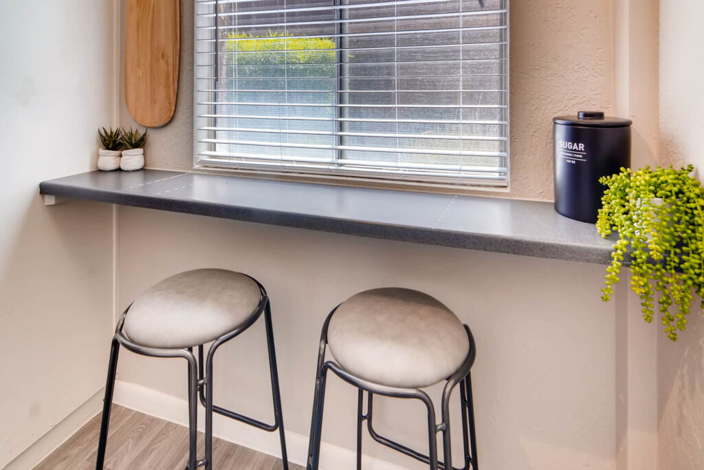 Bar seating in front of window in the kitchen